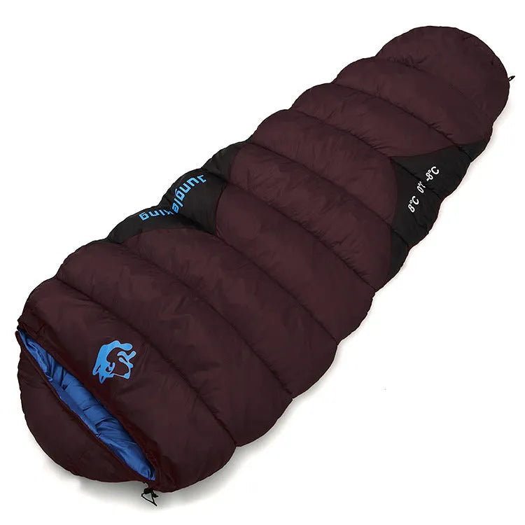 Brown cotton camping sleeping bag partially rolled next to its grey compression storage sack.