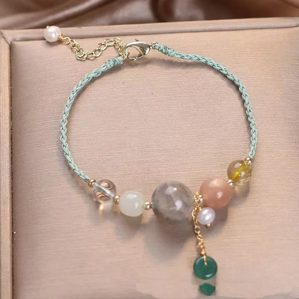 Hand-woven women's bracelet with a crystal buckle and sequins on blue string.