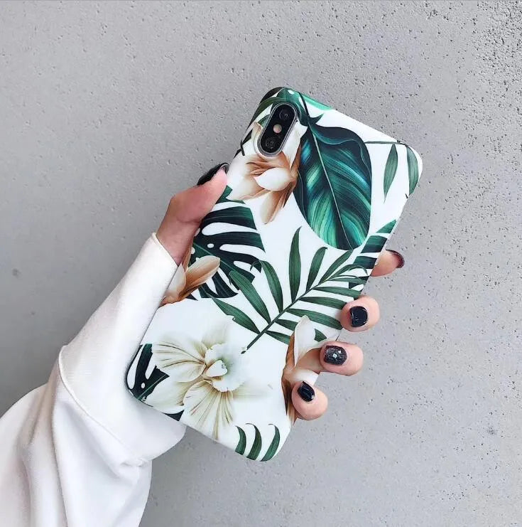 Soft TPU iPhone case with green banana leaf and pink floral art design on a white background.
