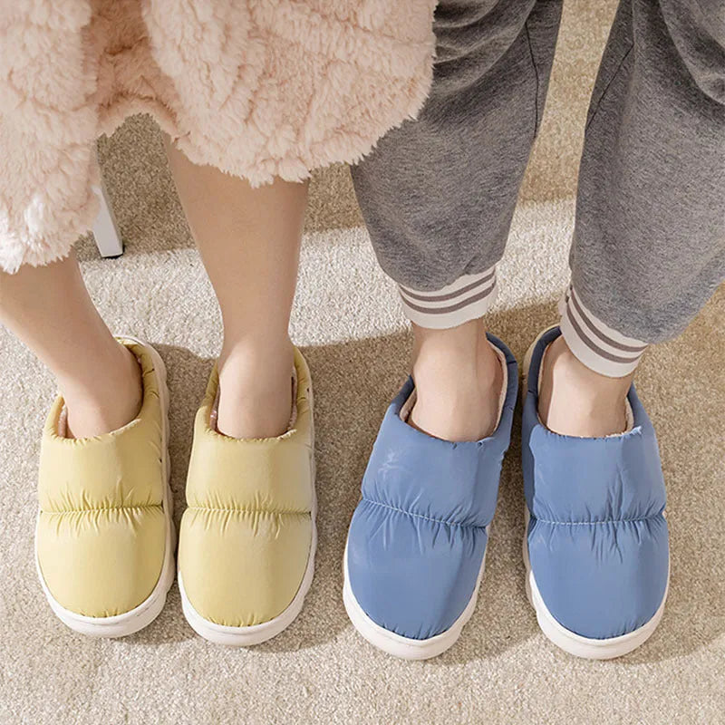 A pair of down cotton slippers with a thick rubber sole and artificial leather upper in a selected colour.