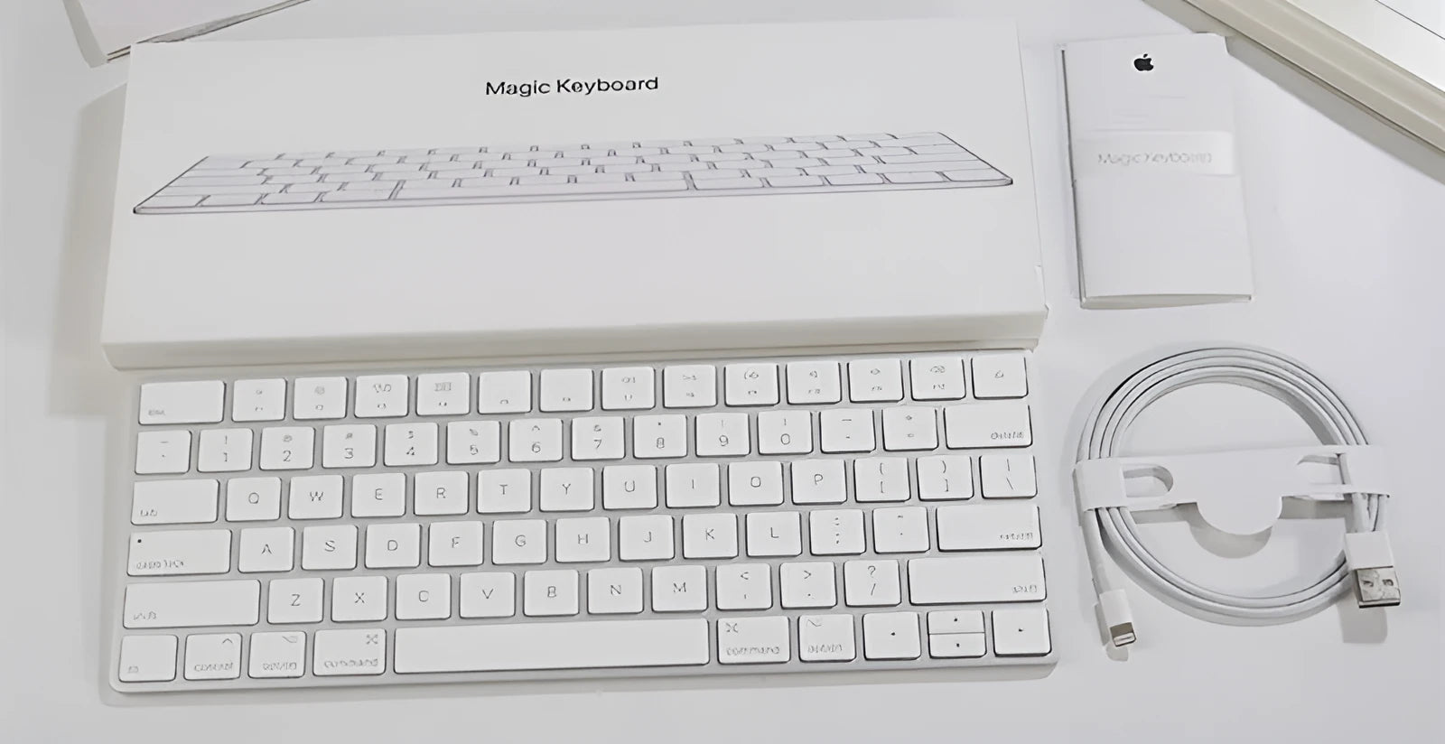 White Apple G6 ultra-thin metal Bluetooth wireless keyboard on a desk.