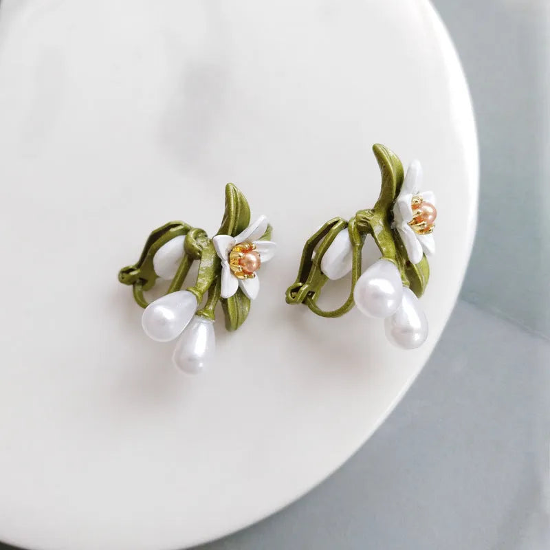 Women's alloy flower earrings showing sterling silver needle detailing on studs and contrast colours on clips