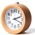 Solid beech wood square alarm clock with traditional analogue dial on wooden surface