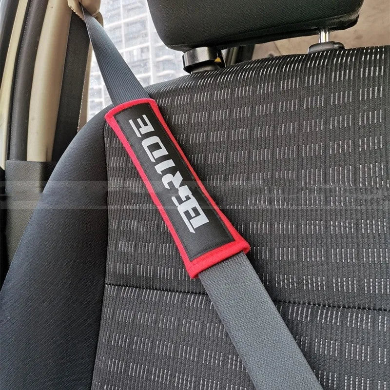 Cotton sponge cloth car seat belt shoulder pads in black, blue, and red colours, showing embroidered weaving detail.