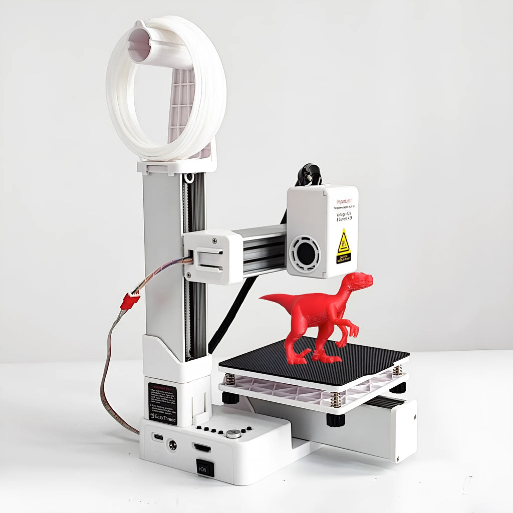 White EasyThreed K10 entry-level 3D printer on a desk, showing its compact size and build plate.