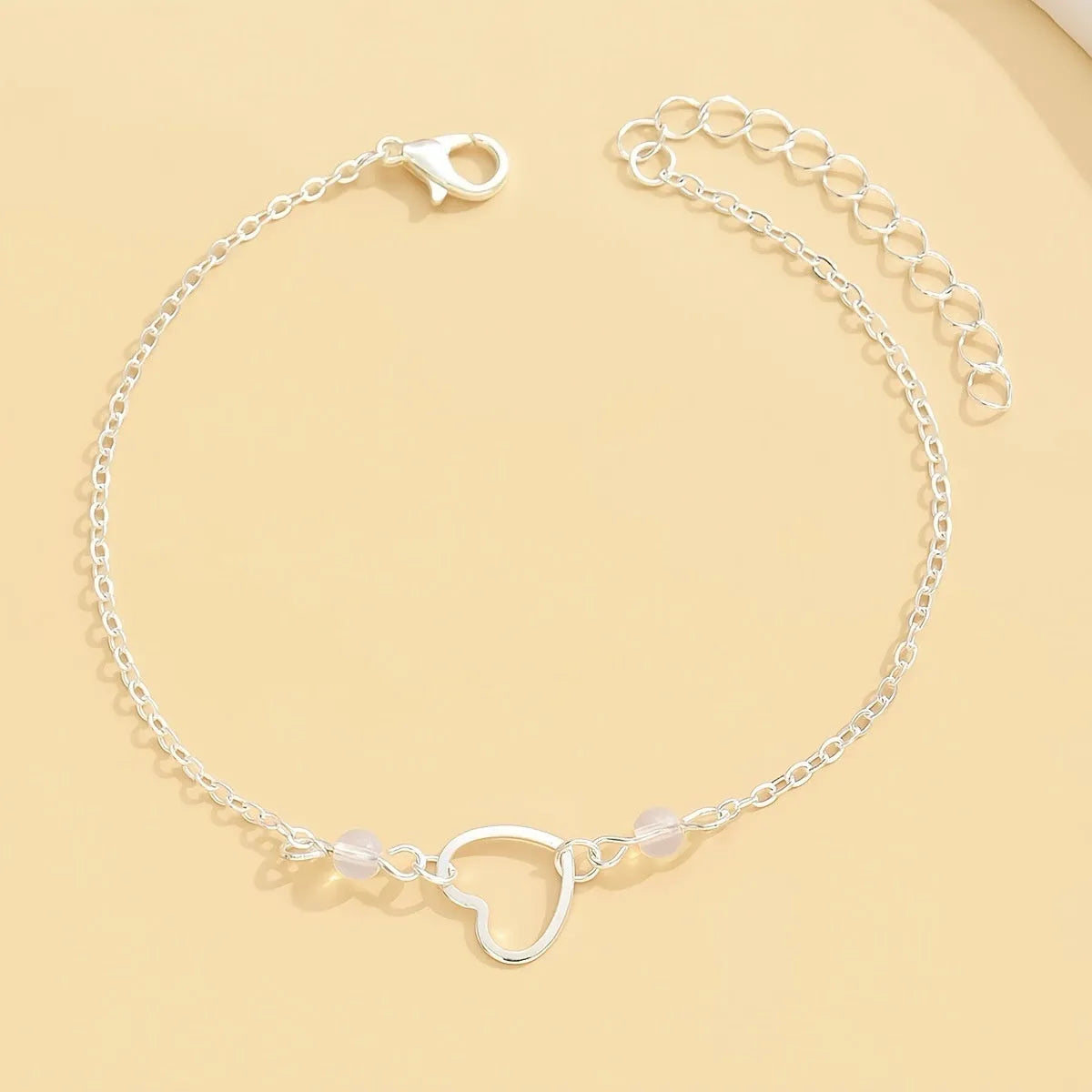 Gold or silver adjustable alloy anklet for women featuring a heart-shaped pendant.