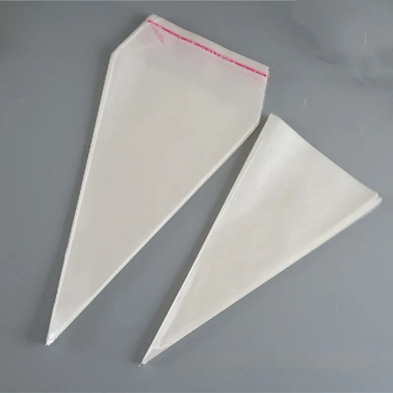 Clear triangle-shaped plastic packaging bags with a twisted wire tie closure on a white background.
