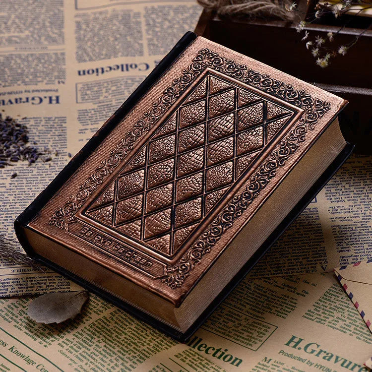 Bronze embossed faux leather A5 notepad with 192 thick unlined pages, lying open.