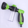 Green high-pressure foam spray gun with adjustable nozzle and attached water hose for car and garden cleaning.