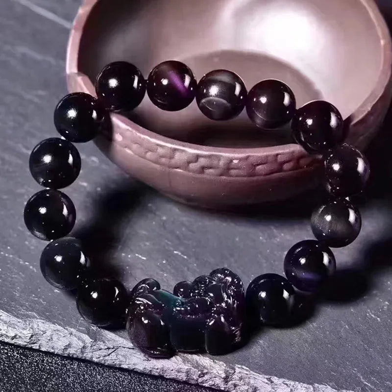 Natural ice colour obsidian crystal bead bracelet showing different bead size options on a wrist.