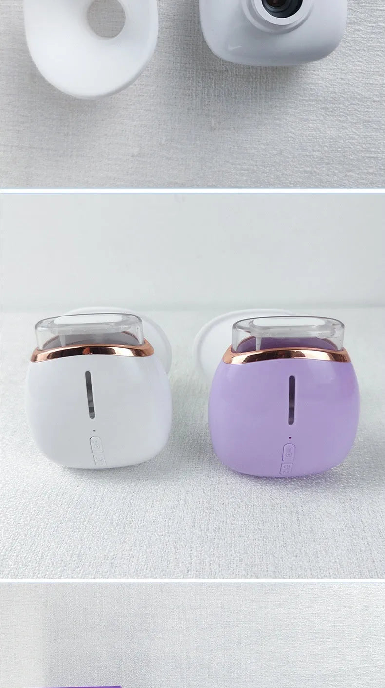 White and purple portable household eye humidifier with charging cable on a table