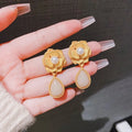Hong Kong style gold colour floral stud earrings with opal stones and needle rose design