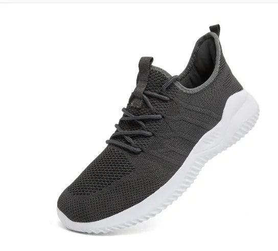Men's black and white mesh sneaker with lace-up closure and round toe on a PVC sole.