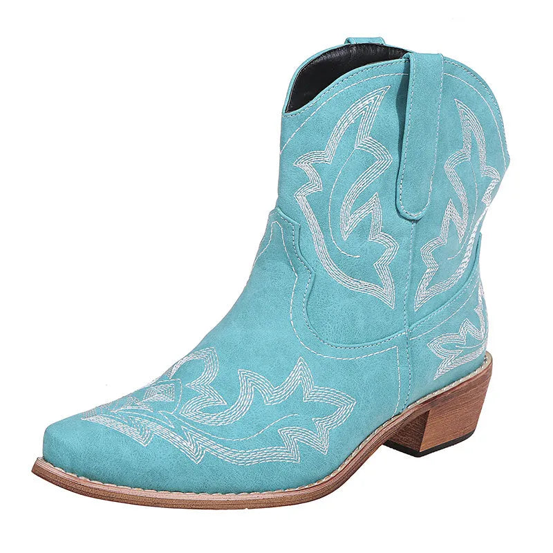 Women's blue cowboy boot with embroidery detail on the side, low wedge heel, and pointed toe.