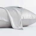 Dark grey envelope-style silk pillowcase laid flat, showing its size and solid colour.