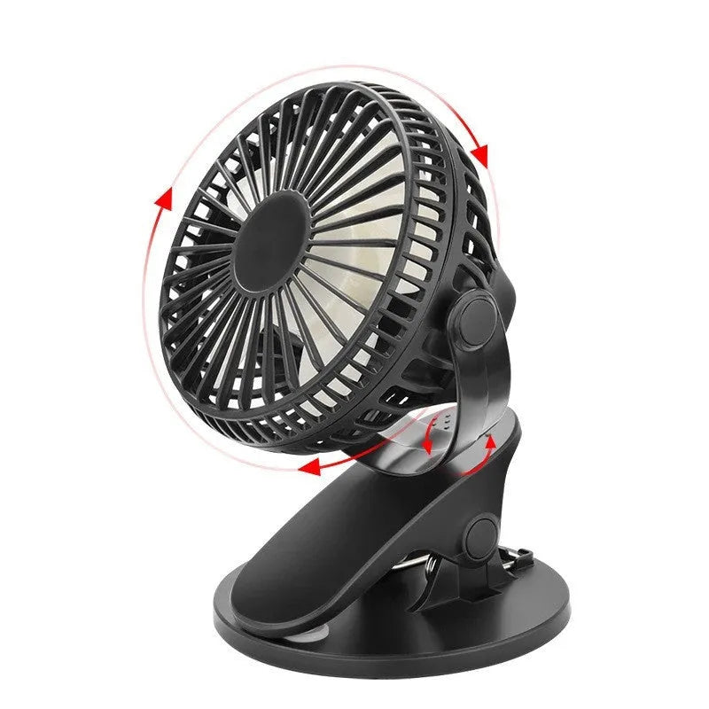 Mini clip fan with USB charging port mounted on desk edge showing plastic blades and piano button controls