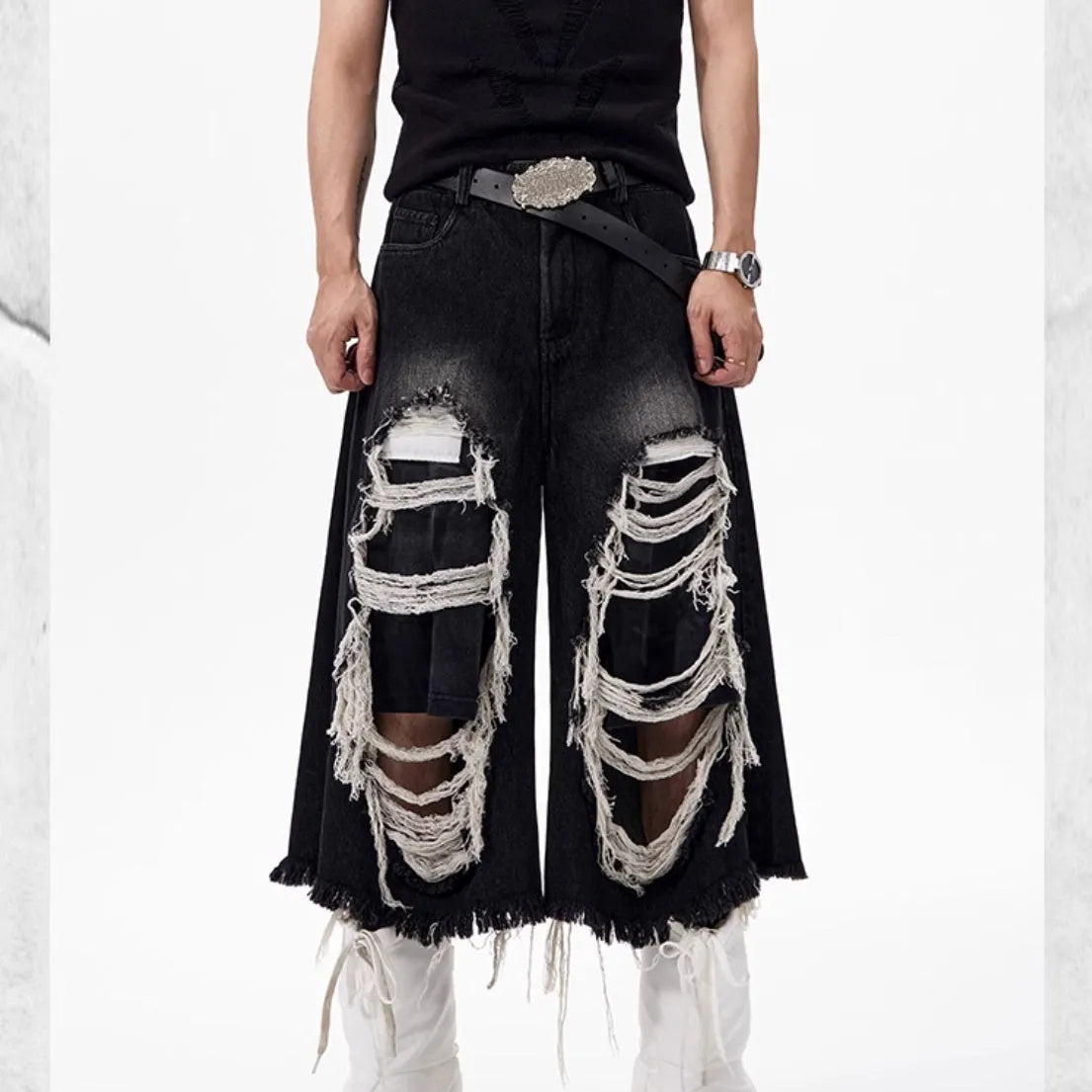 Black women's cropped wide leg jeans with ripped patch details and a mid-high waist.