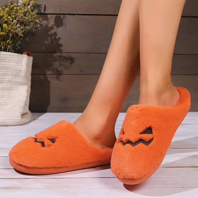 Orange Halloween pumpkin design plush slippers with coral velvet upper and non-slip sole.