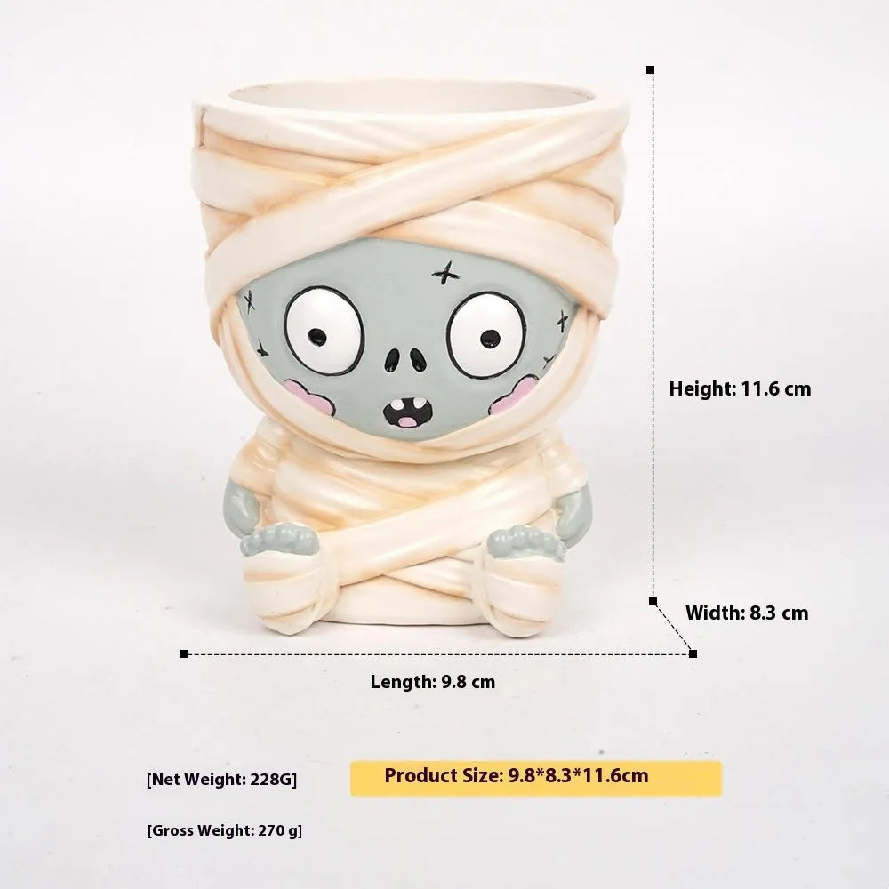 Four Halloween resin flower pot decorations showing bandage zombie, white ghost, science green freak and death designs
