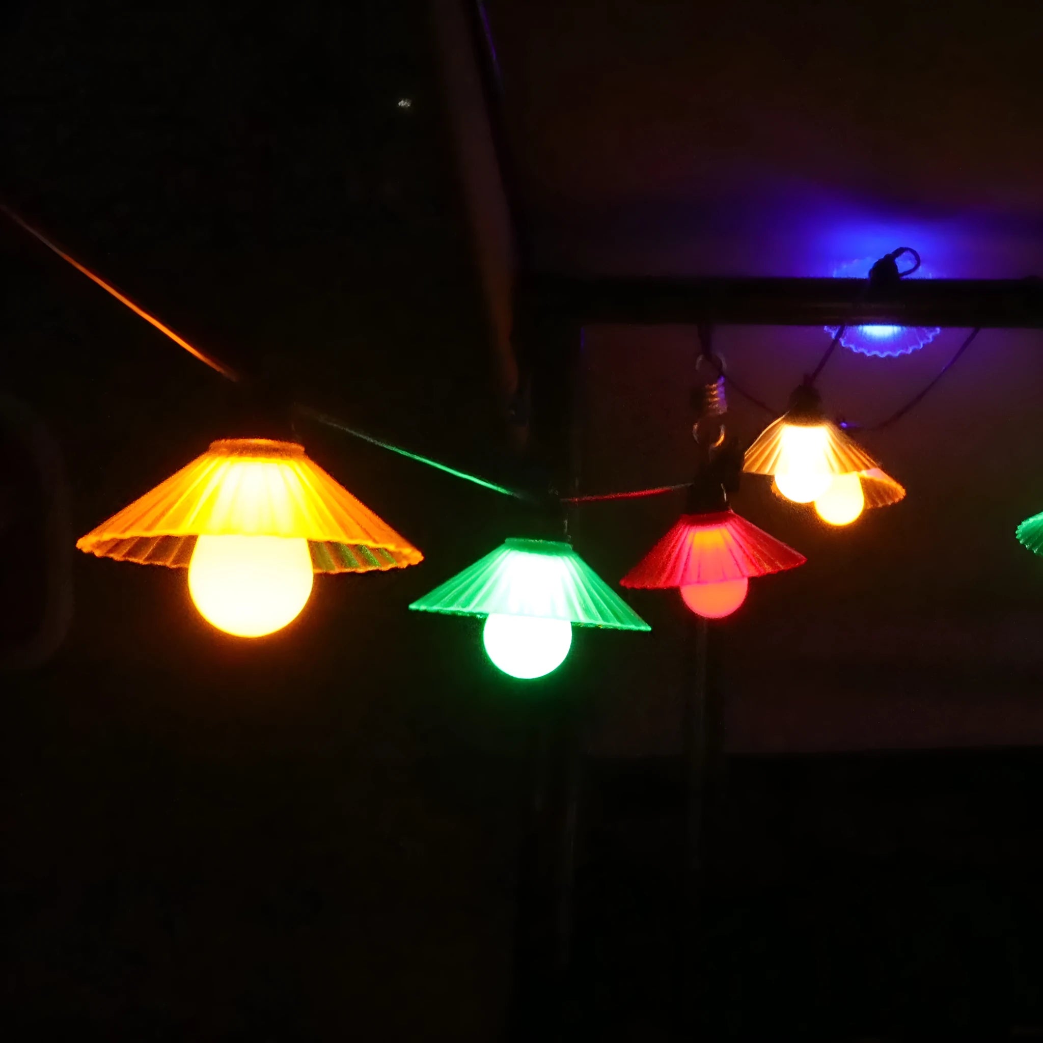 Outdoor LED string lights with flower-shaped bulbs showing IP65 waterproof rating for courtyard and camping use