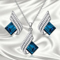 Glass and alloy necklace and earring set with cross chain design and electroplated metallic finish