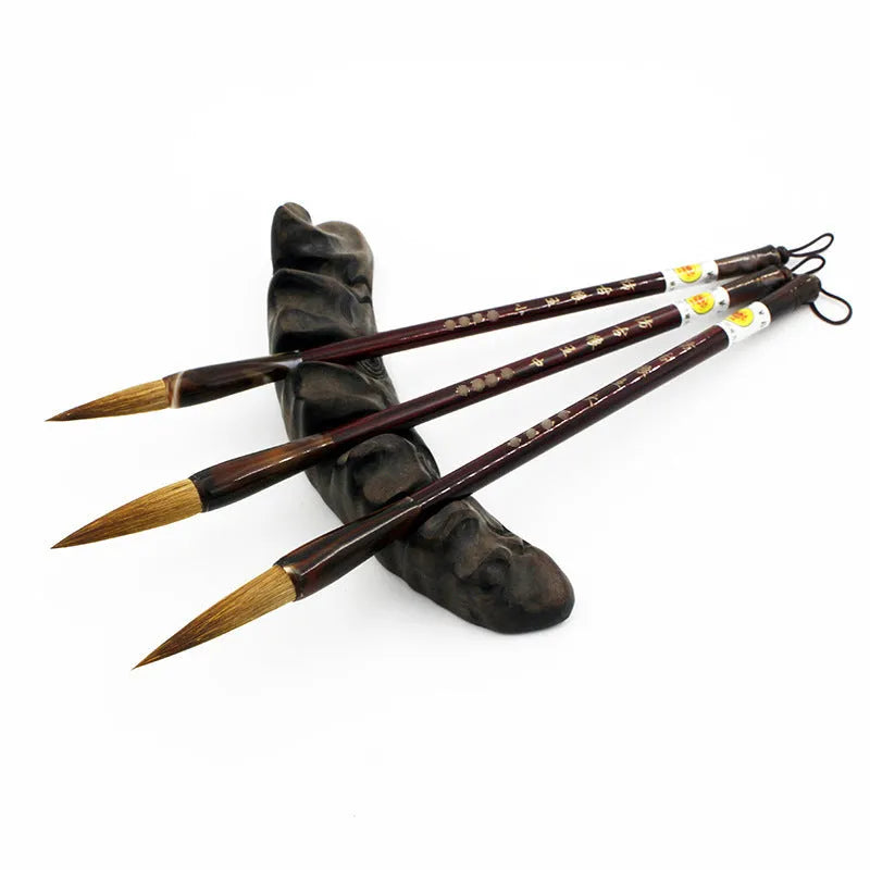 Traditional wolf hair calligraphy brush with steel rod handle in large, medium, and small sizes.