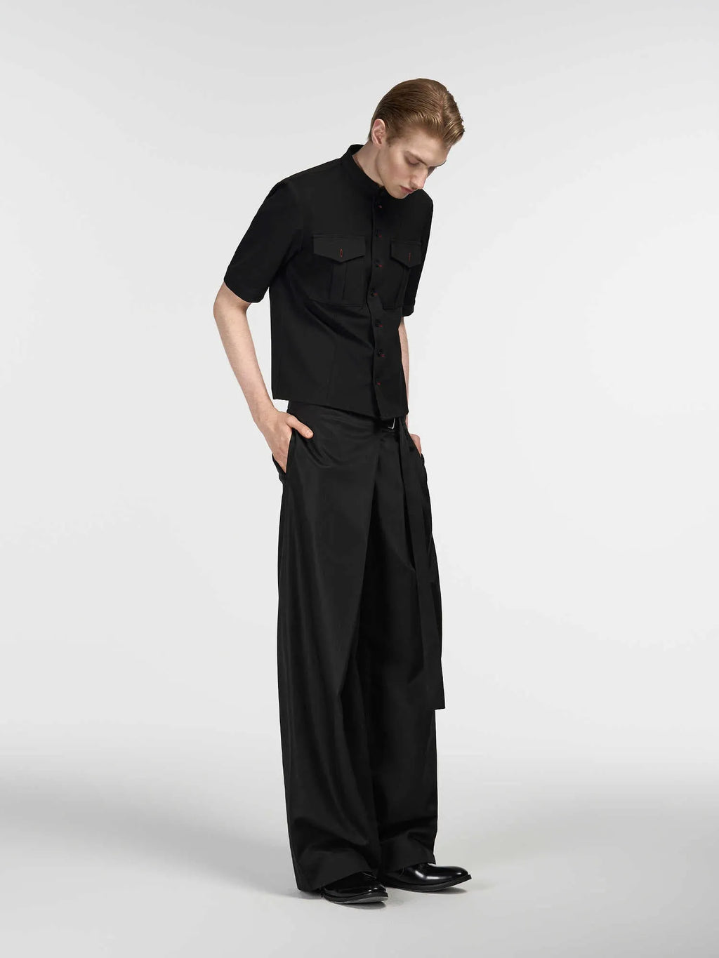 Black straight-leg women's trousers with a front pleat and adjustable waistband on a hanger.