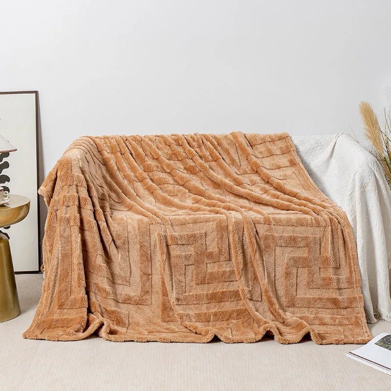 Brown coral fleece sofa throw blanket draped over a grey sofa.