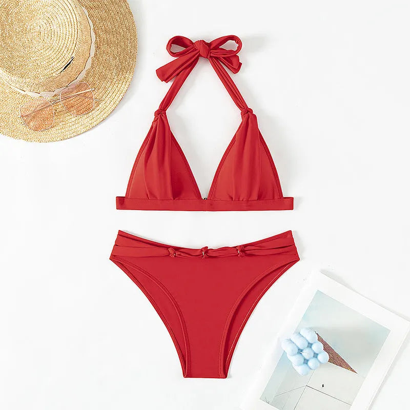 Red women's lace-up halterneck bikini with split shorts for beach swimming