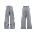 Men's dark grey V-neck cotton sports jacket with padded shoulders and metal detail, worn with matching shorts