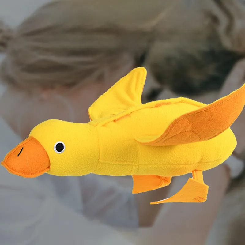 Yellow plush duck dog training toy with squeaker and treat dispensing features