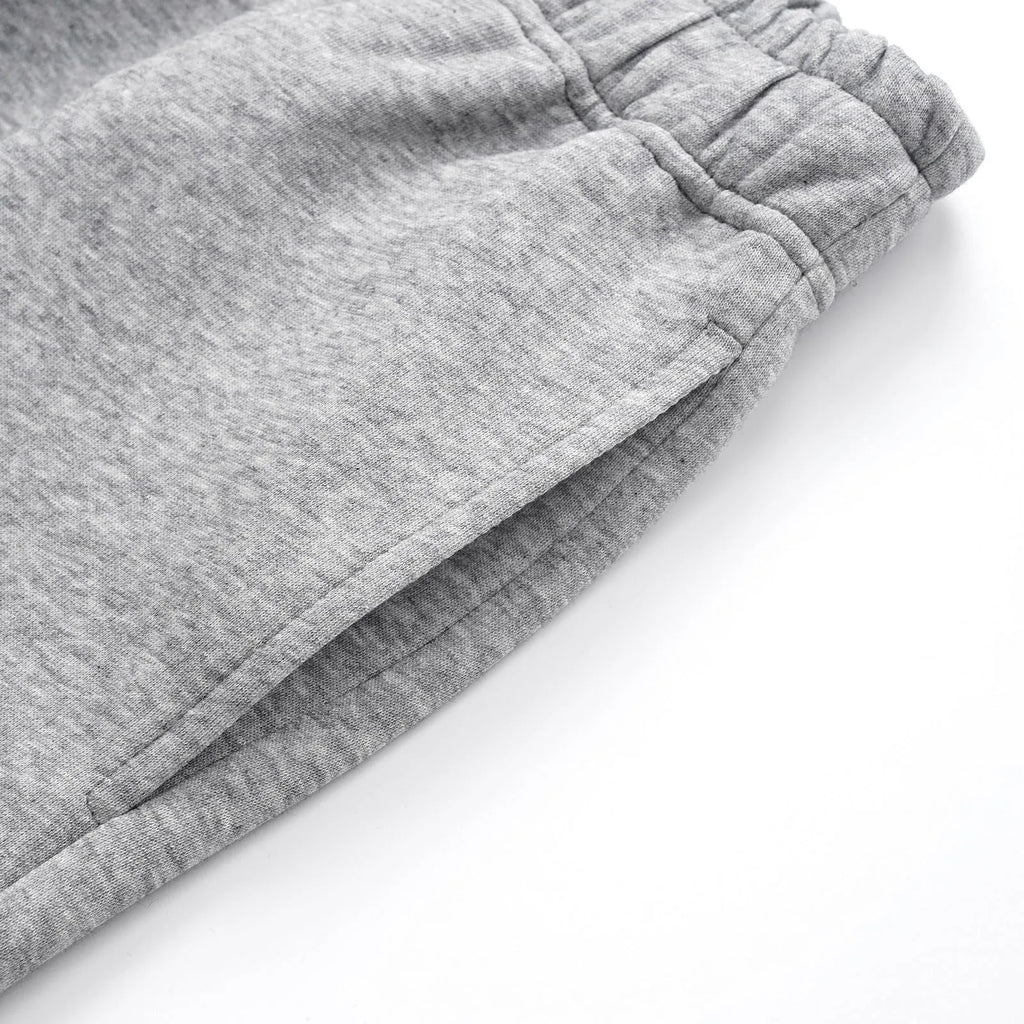 Men's straight-leg cotton casual trousers in grey and black, laid flat showing mid-rise waist and straight leg cut.