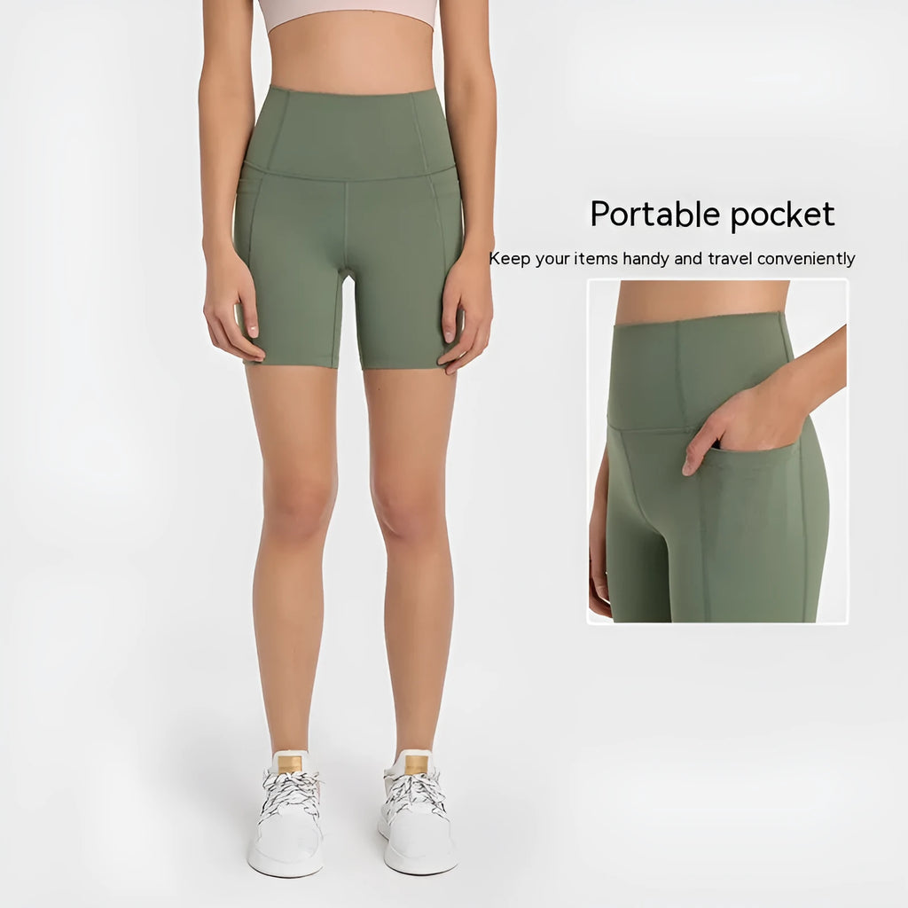 Women's tight-fitting sport shorts in a solid colour, shown on a model for running or gym use.