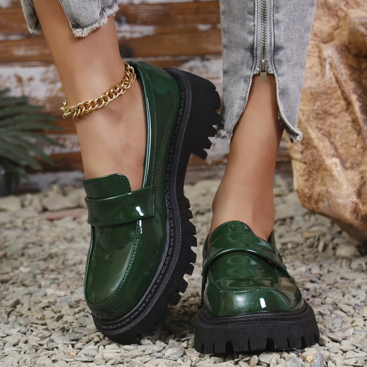 Women's black slip-on loafers with a chunky platform heel and rubber sole.