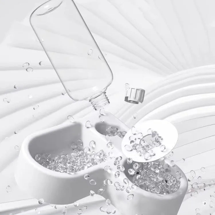 White pet water fountain with stainless steel top, showing water flowing from the centre.