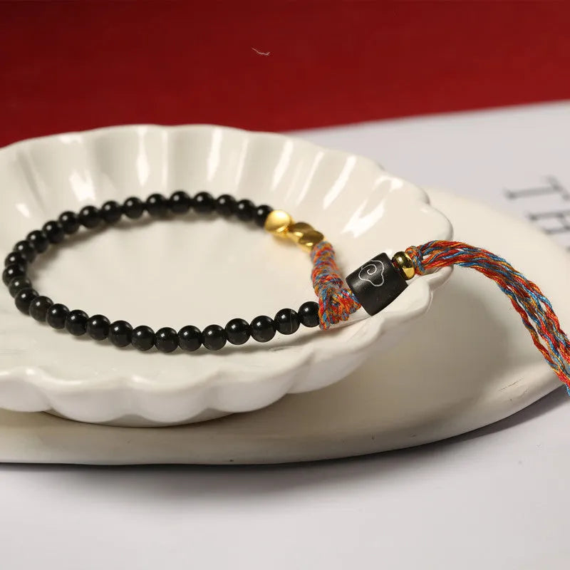 Hand-woven obsidian carrying strap showing woven texture and adjustable 15.5-16cm length