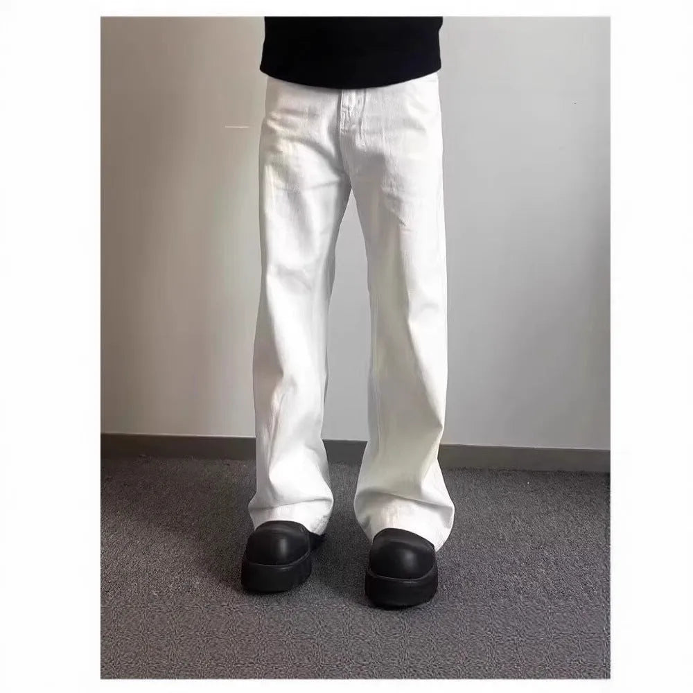 Men's white loose fit straight leg denim jeans on a mid waist with a zipper fly.