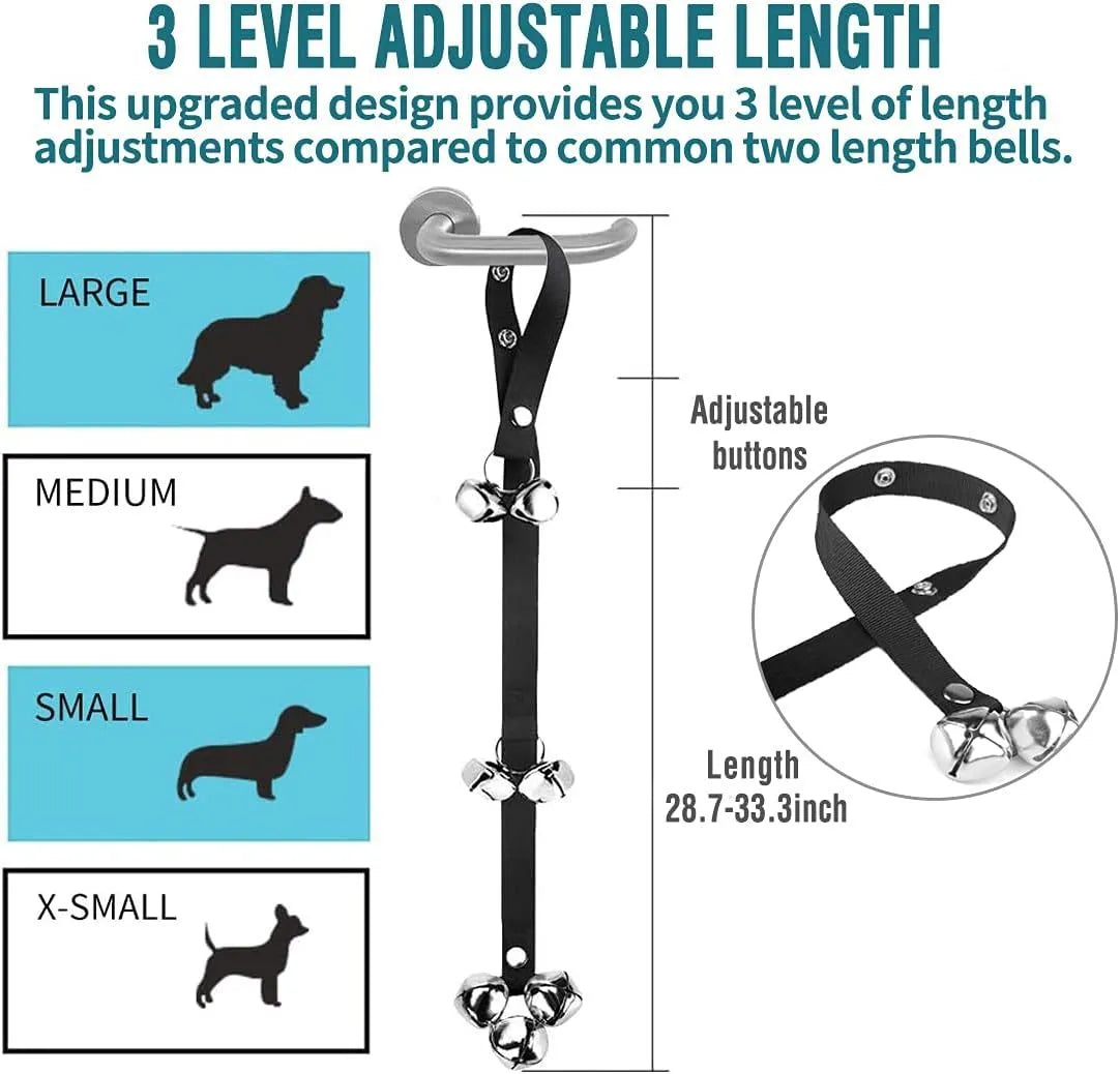 Silver metal dog training bells on an adjustable black nylon strap hanging on a door.