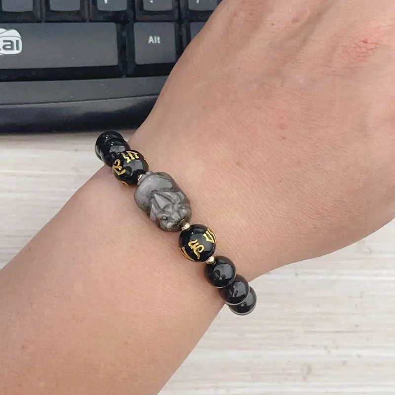 Close-up of a men's adjustable Silverstone bracelet with Chinese zodiac beads and six-word proverbs.