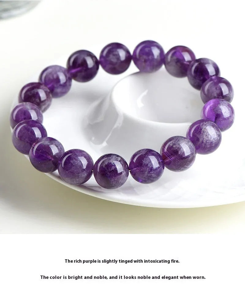 Natural feather amethyst crystal bracelet with scattered beads and Ruyi element on wrist.