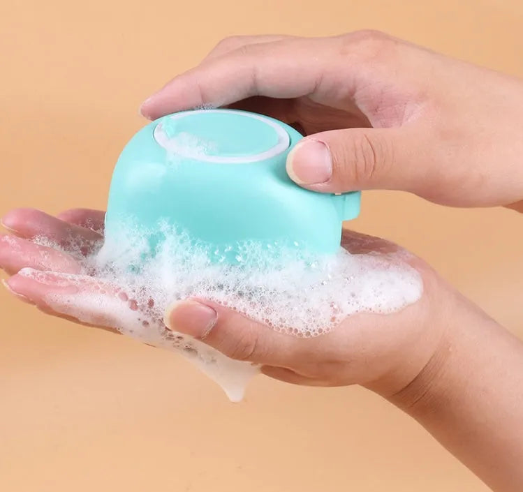 Blue silicone dog bath brush with non-slip handle for washing and massage.
