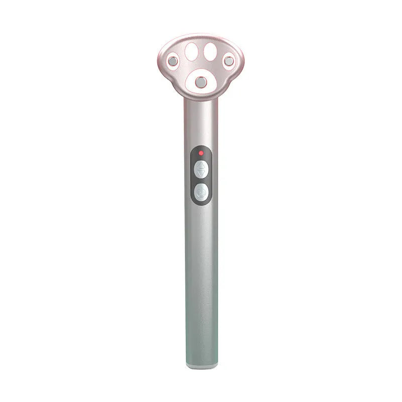 Cat's paw shaped micro-current eye massager in gradient pink with charging cable