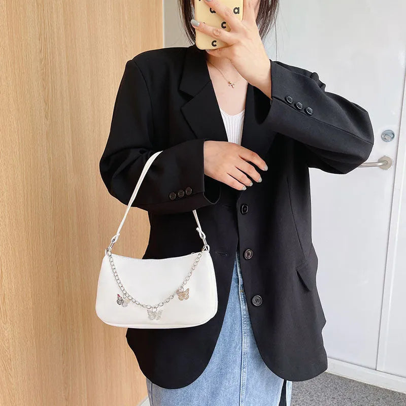 Horizontal square PU crossbody bag with chain strap in retro style showing internal phone and document pockets.