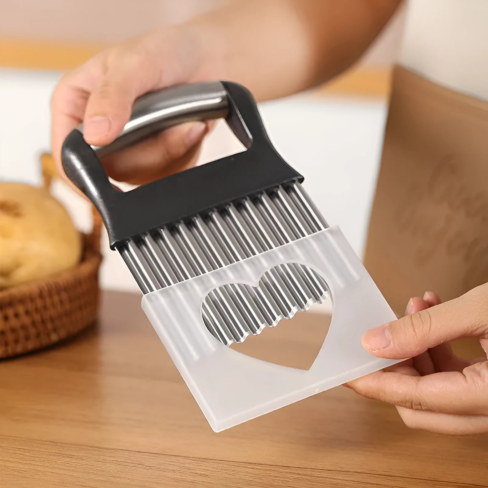 Stainless steel potato wave knife for making wavy-cut chips, shown with black handle.