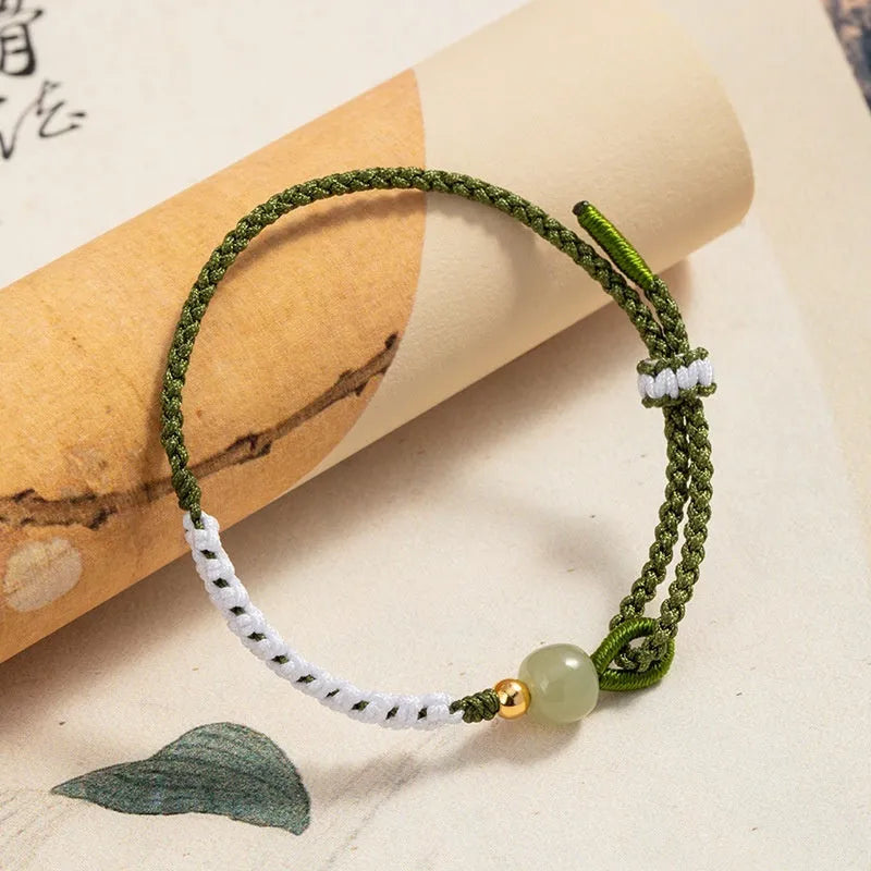 Chinese national bracelet with colourful cord carrying strap and electroplated sterling silver fittings
