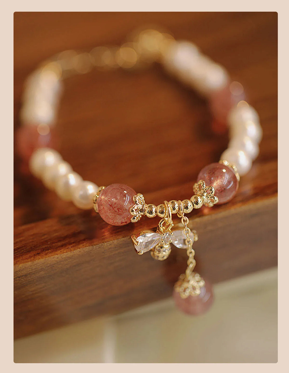 Women's strawberry quartz bracelet with stringed pearls and bow detail in INS style