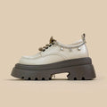 British style white platform leather Mary Jane shoes with chunky heel and lace-up front.