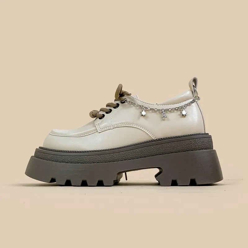 British style white platform leather Mary Jane shoes with chunky heel and lace-up front.