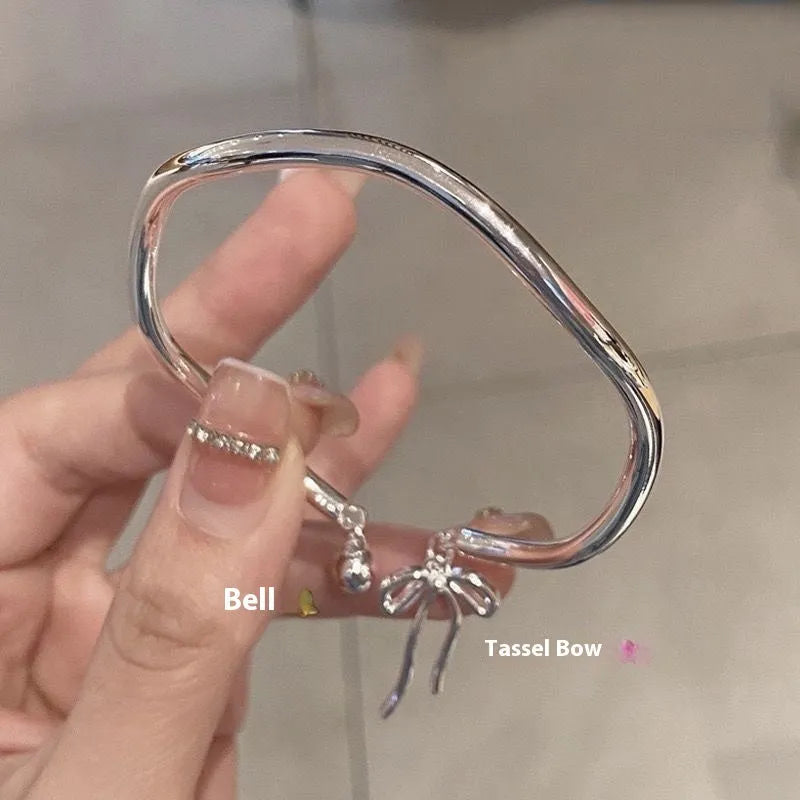 Silver adjustable bracelet with bow decoration and bell opening clasp on zinc alloy chain