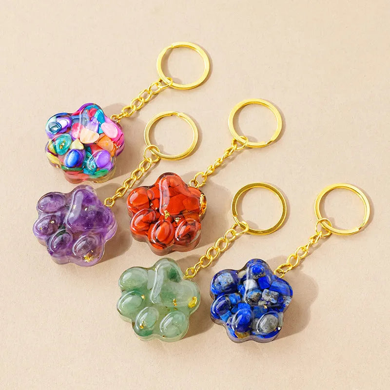 Small natural crystal cat's paw charm on a metal keyring loop.